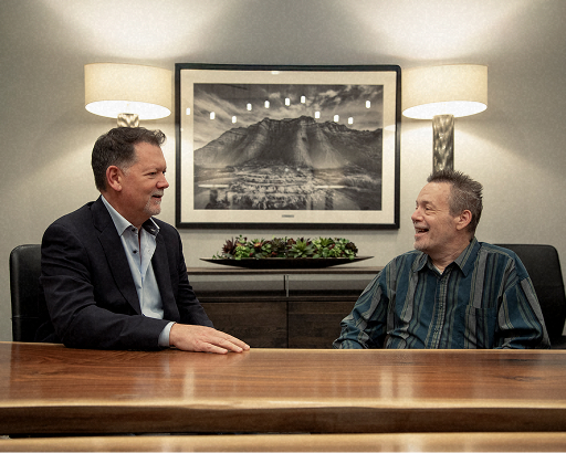 Attorney Dean Boyd and client talking in a professional office meeting.