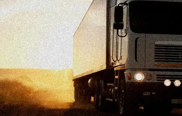 Semi-truck driving on a road at sunset with golden light | Semi-truck wrecks.