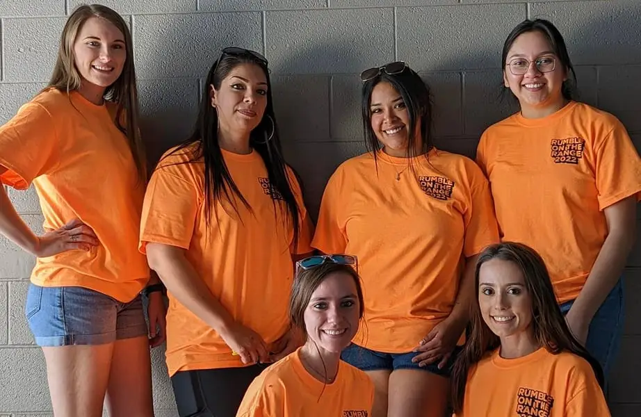 Attorney Dean Boyd team members wearing orange Rumble on the Range shirts